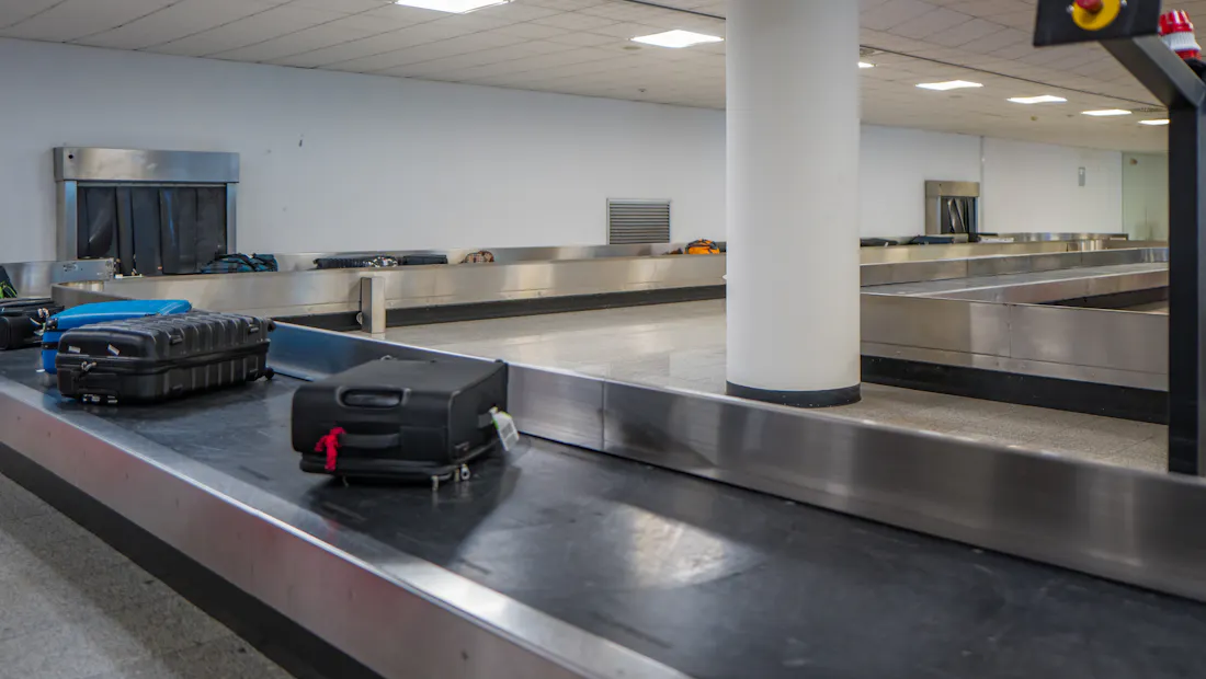 Suitcases on a baggage reclaim belt at an airport