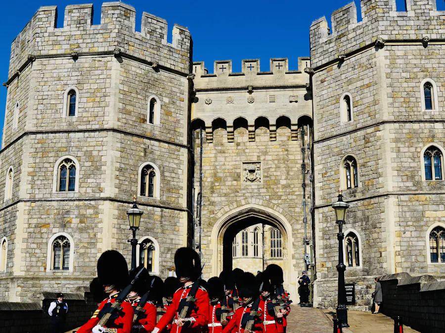 Guardsmen in red tunics marching through the gate of Windsor Castle
